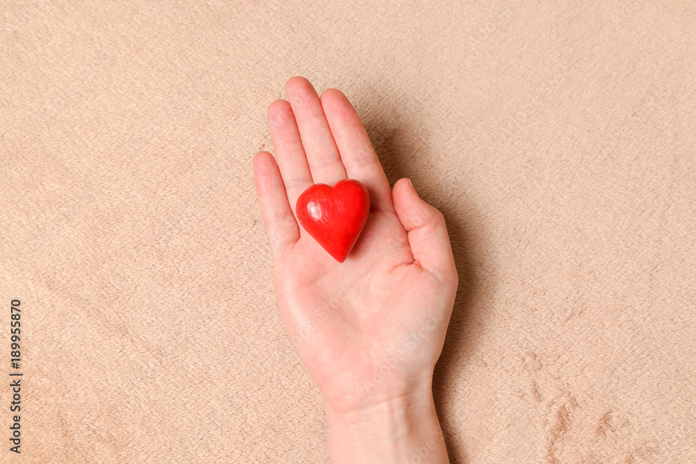 Hands hold red decorative heart Hands hold red decorative heart