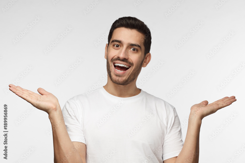 Surprised astonished hesitant man being shocked to hear unexpected news, looks with opened mouth at camera, gesturing with both hands Surprised astonished hesitant man being shocked to hear unexpected news, looks with opened mouth at camera, gesturing with both hands