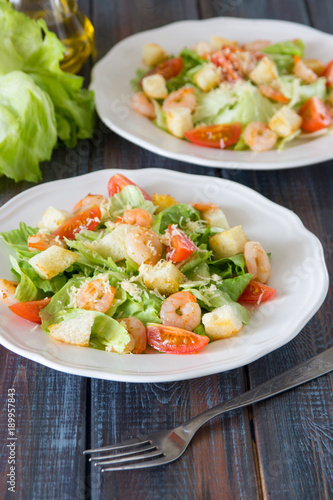 Caesar salad with shrimps, cherry tomato, croutons, salad leaf and parmesan cheese