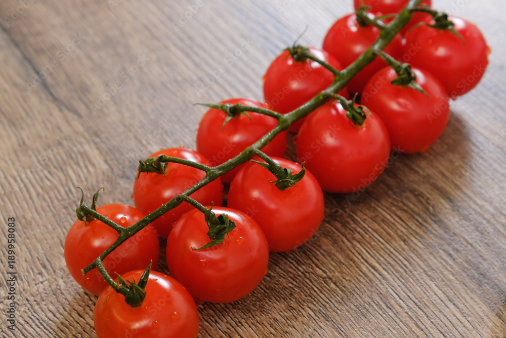 Cherry tomatoes on the wooden table Cherry tomatoes on the wooden table