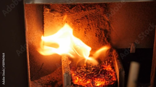 A dolly shot of pellet stove heating a room