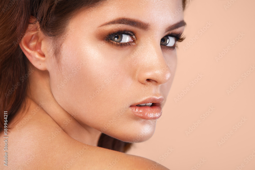 Closeup portrait of beautiful young woman with clean and fresh skin. Nude makeup. Facial treatment . Concept for cosmetology, beauty and spa . Closeup portrait of beautiful young woman with clean and fresh skin. Nude makeup. Facial treatment . Concept for cosmetology, beauty and spa .