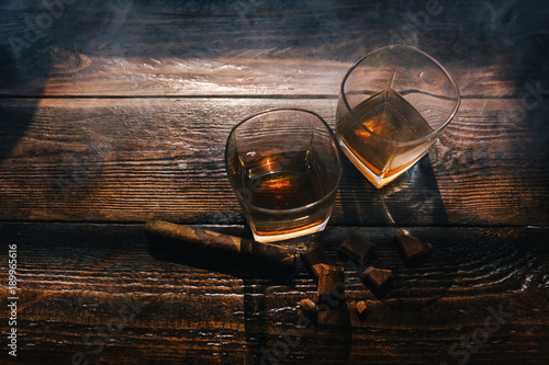 alcohol drinks and cigar on wooden background. Wealthy men indulgent luxury lifestyle concept