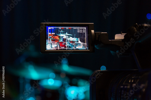The LCD display on the camcorder. Filming the concert. Drum set and bass.