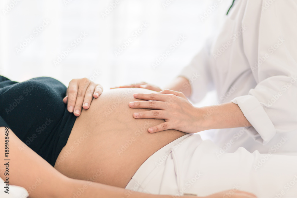 Female Obstetrician doctor Examination  to a pregnant woman  at hospital.