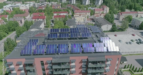 Midday Aerial View Of Apartment House with solar panels on roof in residential are of Lahti, Finland, Sideways movement