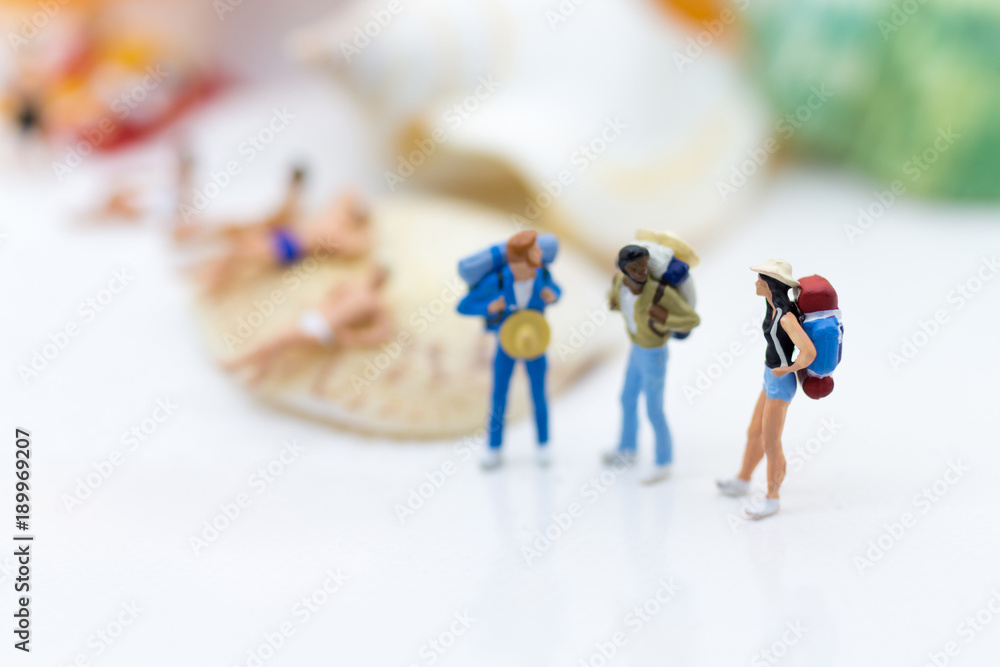 Miniature people : Backpackers travel at beach on vacation. Image use for business travel concept.