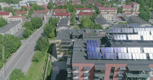 Midday Aerial View Of Apartment House with solar panels on roof in residential are of Lahti, Finland, Sideways movement