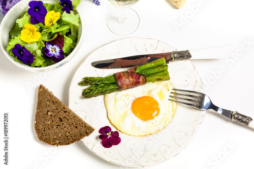 Egg with asparagus and bacon on a Mediterranean style photo