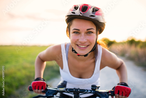 funny girl on a bicycle outside the city