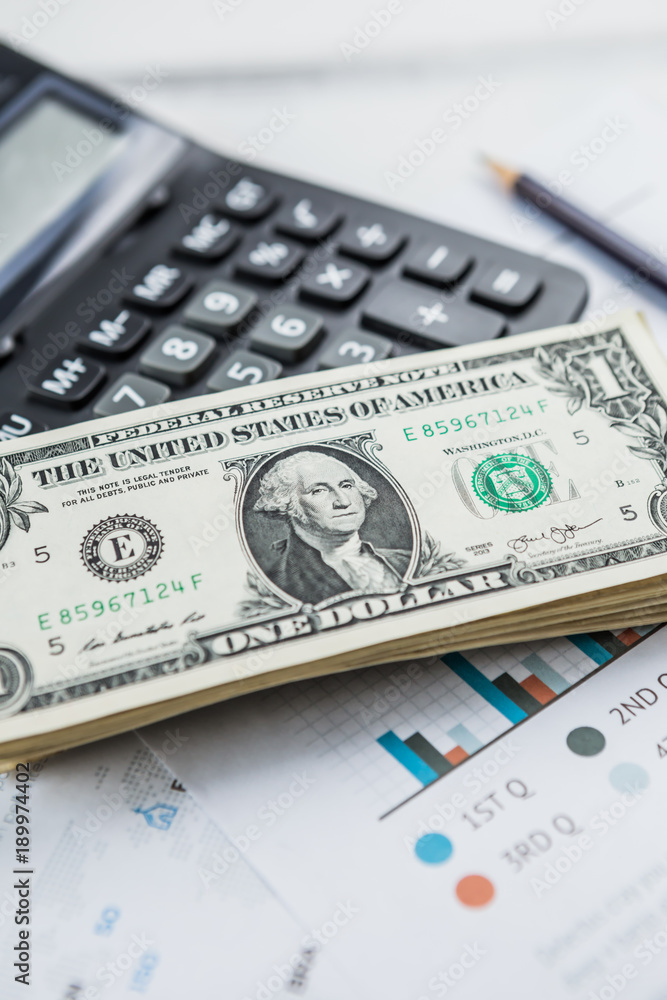 Calculator with american dollars on the wooden table background, finance concept Calculator with american dollars on the wooden table background, finance concept