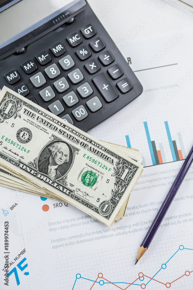 Calculator with american dollars on the wooden table background, finance concept Calculator with american dollars on the wooden table background, finance concept