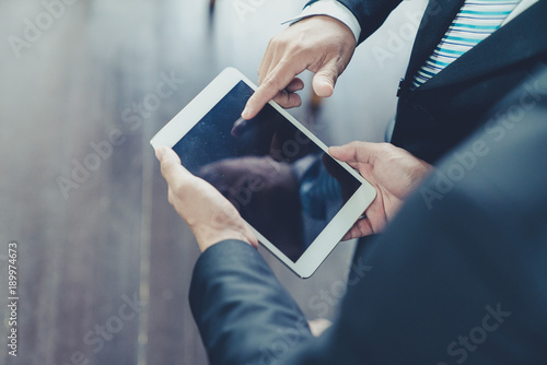 Businessman use computer tablet for work in communication around worldwide to success marketing plan of company