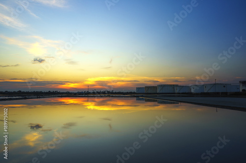 White oil tank, water reflection, beautiful evening