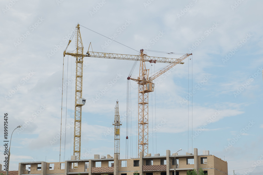 Construction of new high buildings with building cranes Construction of new high buildings with building cranes