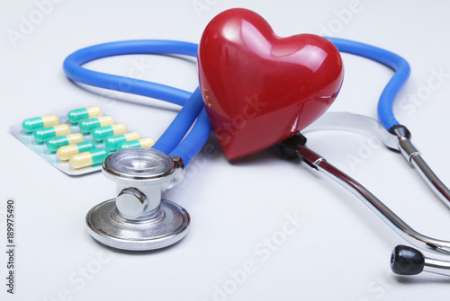RX prescription, stethoscope, Red heart and pils on white background