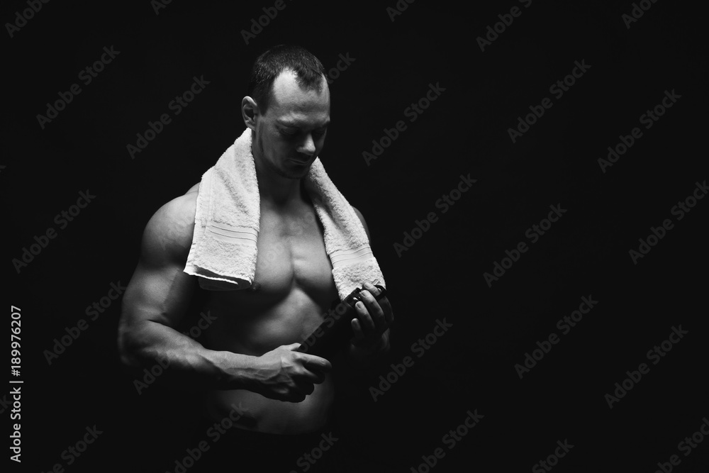 Male bodybuilder drinking water after workout Male bodybuilder drinking water after workout