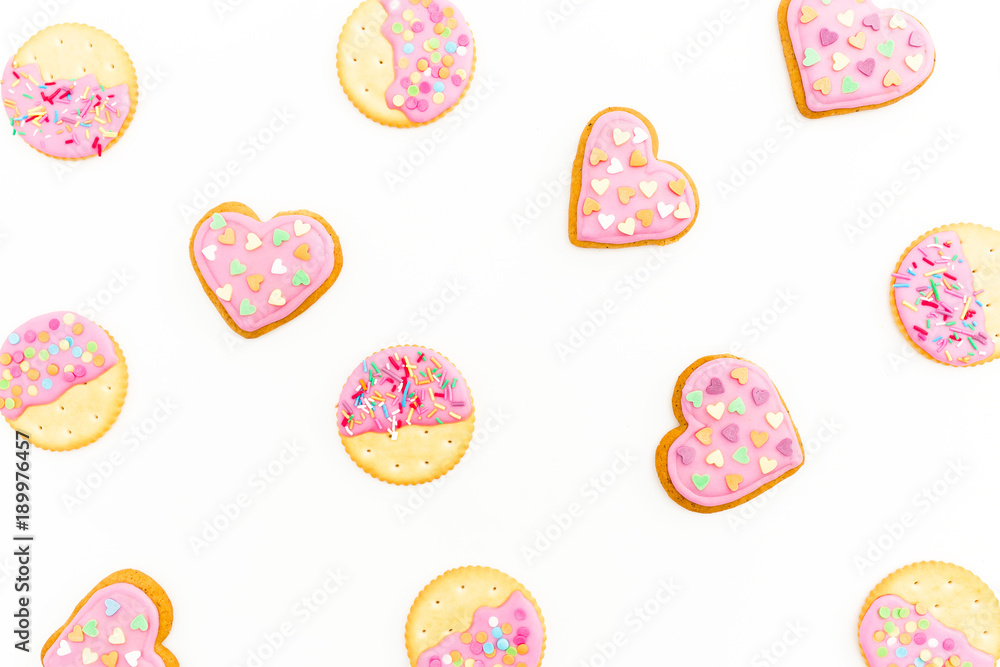 Food pattern made of pink gingerbread cookies isolated on white background. Flat lay. top view. Food pattern made of pink gingerbread cookies isolated on white background. Flat lay. top view.