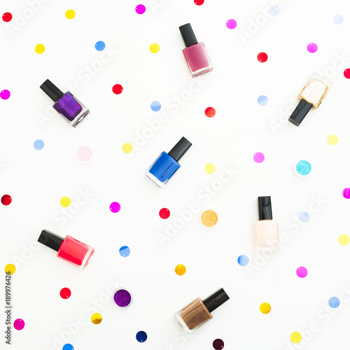 Beauty composition with bright nail polish on white background. Flat lay, top view. Beauty blog concept