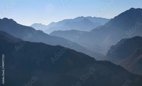 mountain panorama in winter with mountain ranges in the fog