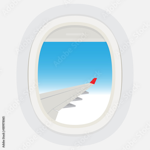 Airplane windows with cloudy blue sky outside.