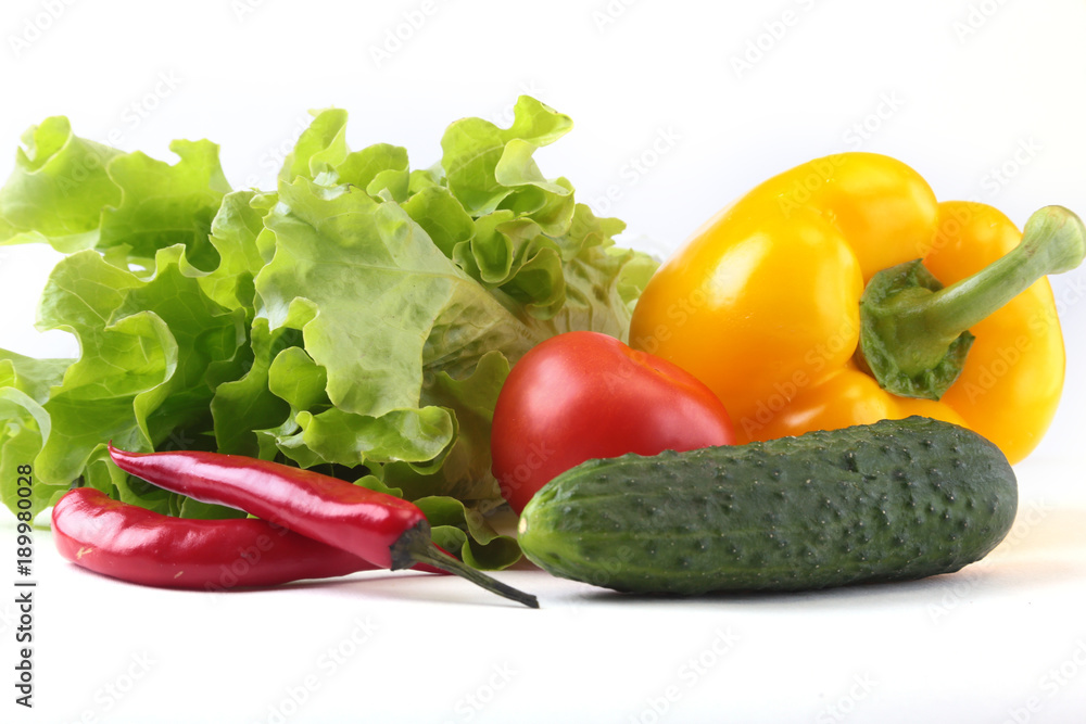 Assorted vegetables, fresh bell pepper, tomato, chilli pepper, cucumber and lettuce isolated on white background. Selective focus. Assorted vegetables, fresh bell pepper, tomato, chilli pepper, cucumber and lettuce isolated on white background. Selective focus.