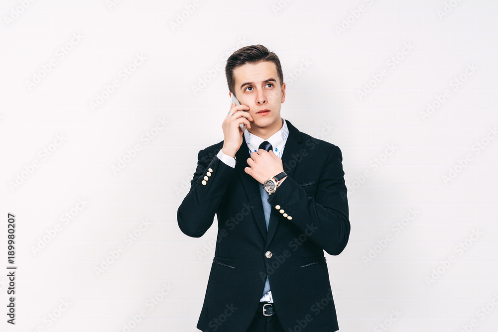 Youn attractive man is talking on the phone, Business concept, copy space Youn attractive man is talking on the phone, Business concept, copy space