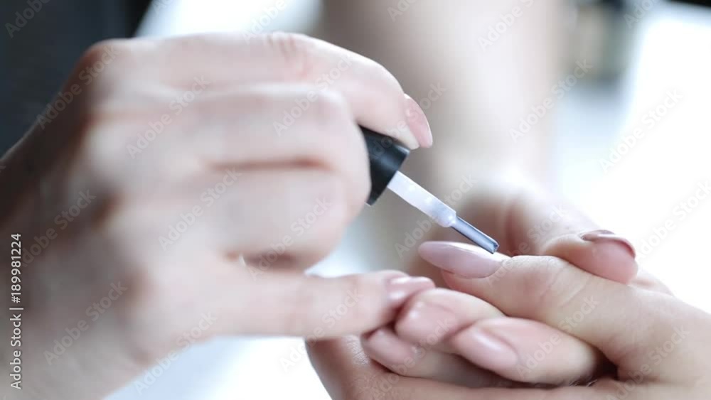 Women paints nails.Manicure Nail Art close up. Beautiful Nail Art Manicure. Nail designs with decoration.Manicure nail paint. Women paints nails.Manicure Nail Art close up. Beautiful Nail Art Manicure. Nail designs with decoration.Manicure nail paint.