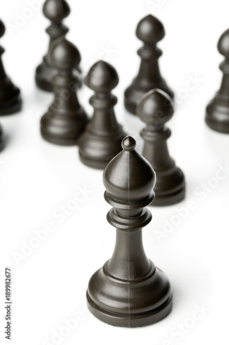 King chess figure in front of pawn chess figures