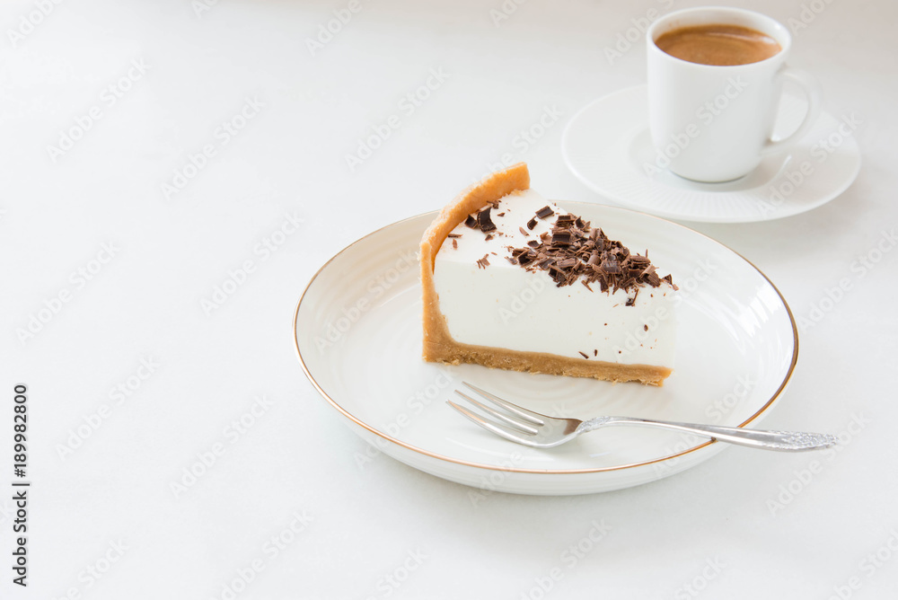 Homemade Cheesecake with chocolate and a cup of coffee on a white background. Homemade Cheesecake with chocolate and a cup of coffee on a white background.