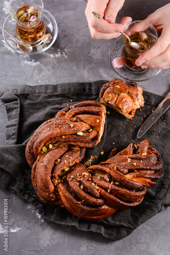 Traditional tea party in Arabic with dates, sweets and turkish bread. Man's hands. photo