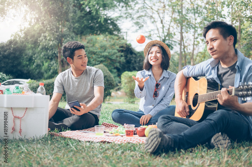 Young teen groups having fun picnic in park together. photo