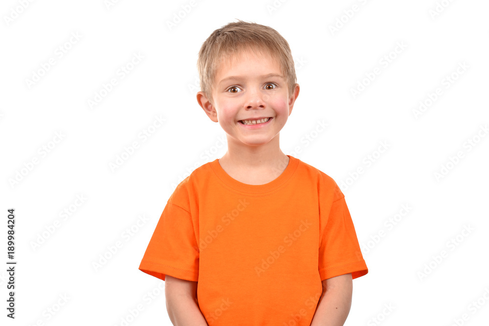 Emotional portrait of a teenager. A boy in an orange t-shirt. Beautiful and happy child isolated on a white background. Emotional portrait of a teenager. A boy in an orange t-shirt. Beautiful and happy child isolated on a white background.