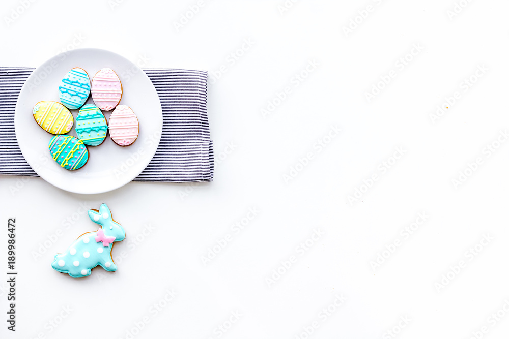 Easter background. Cookies in shape of easter bunny and easter eggs. White background top view space for text Easter background. Cookies in shape of easter bunny and easter eggs. White background top view space for text
