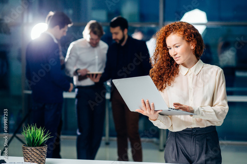 Fotografie Portrait of a smiling young businesswoman using tablet in the office