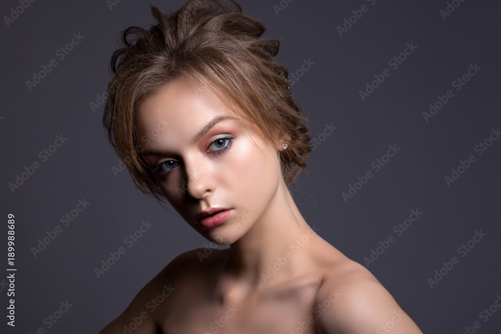 Portrait of a beautiful teenage girl on a gray background. Portrait of a beautiful teenage girl on a gray background.
