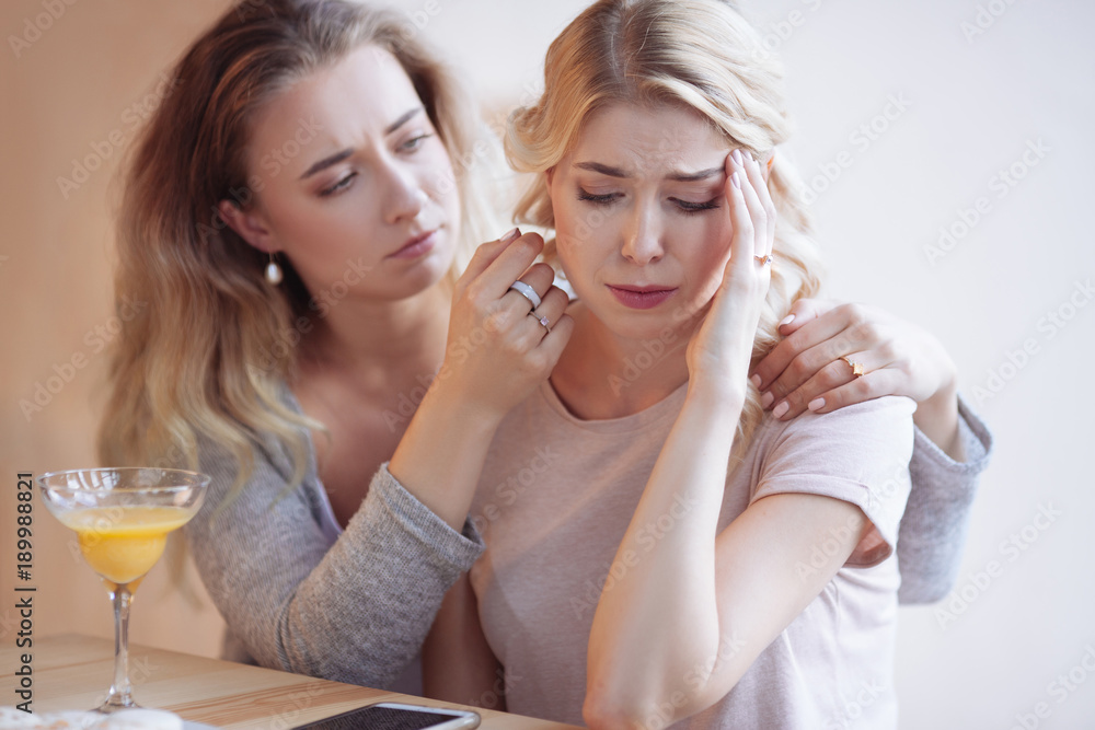 Cheerless young woman holding her forehead Cheerless young woman holding her forehead