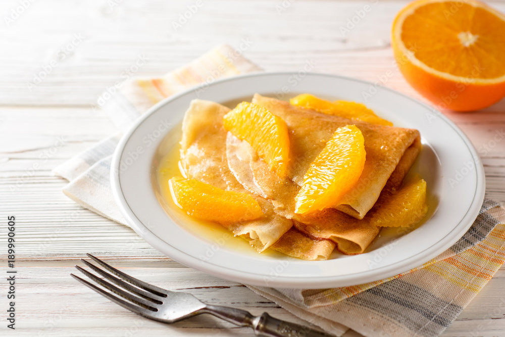 Crepe suzette, traditional french dessert with thin pancakes and orange sauce.