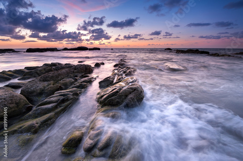 waves trail during sunset at unknown beach in Sabah, Malaysia.