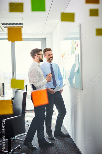 Two business colleauges working in office together on new strategy photo