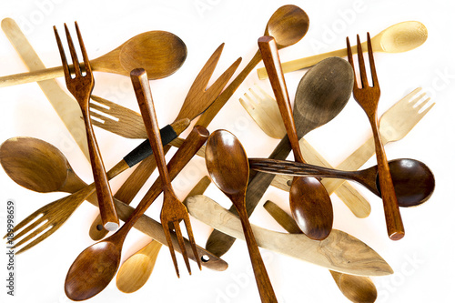 Wooden knifes, spoons and forks on white background