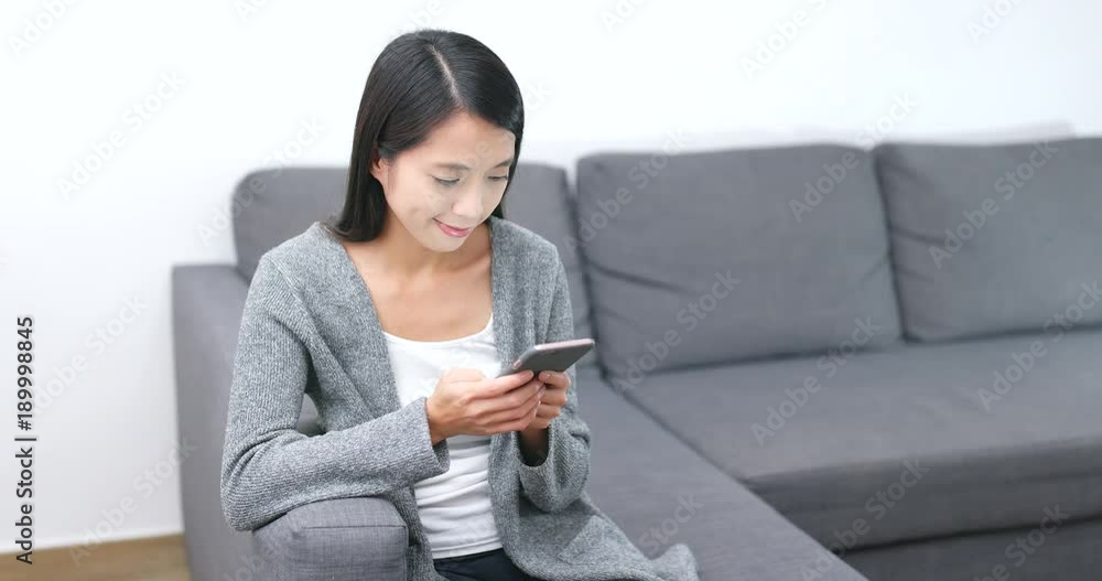 Woman use of mobile phone at home Woman use of mobile phone at home
