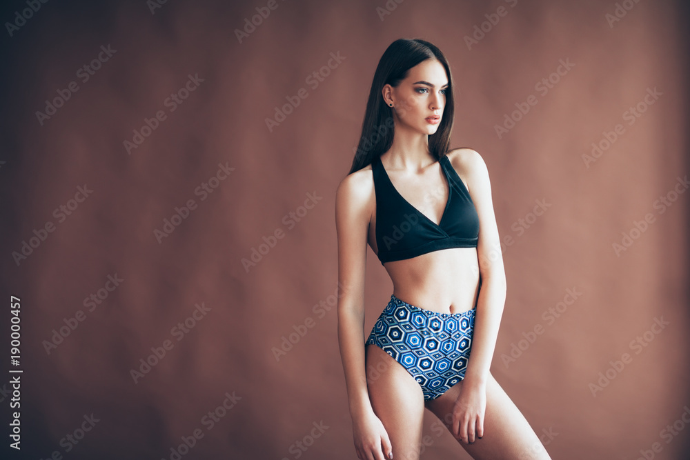 Fototapeta premium Young beautiful woman posing in studio