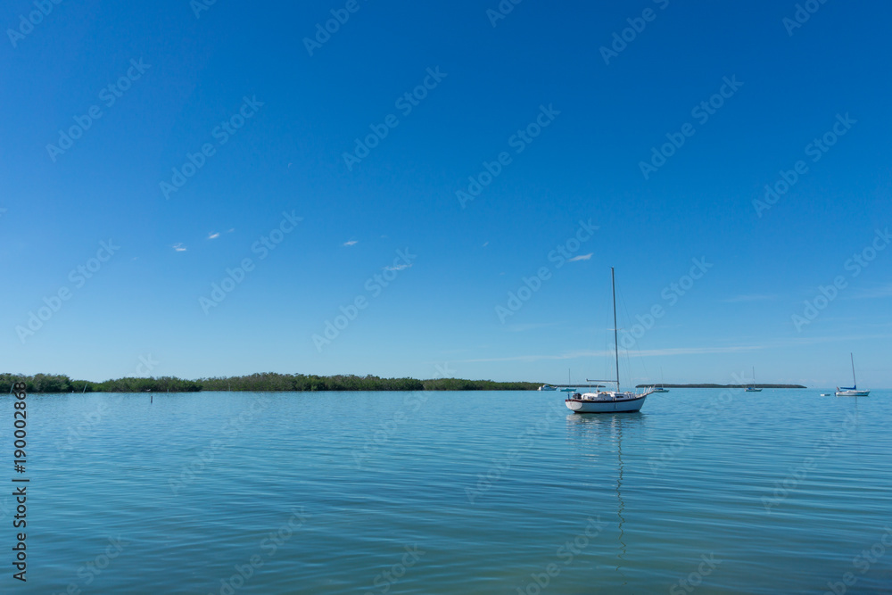 USA, Florida, Sailboats on the silent water of florida keys between mangrove islands