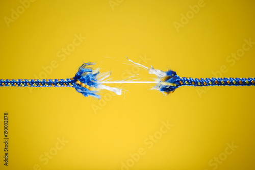 Tension, stress and risk concept - damaged rope photo