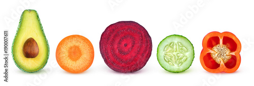 Isolated vegetable slices. Fresh vegetables cut in half (avocado, carrot, beetroot, cucumber, bell pepper) in a row isolated on white background with clipping path