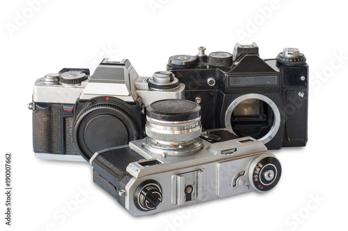 Old vintage black and silver cameras on a white background, isolated