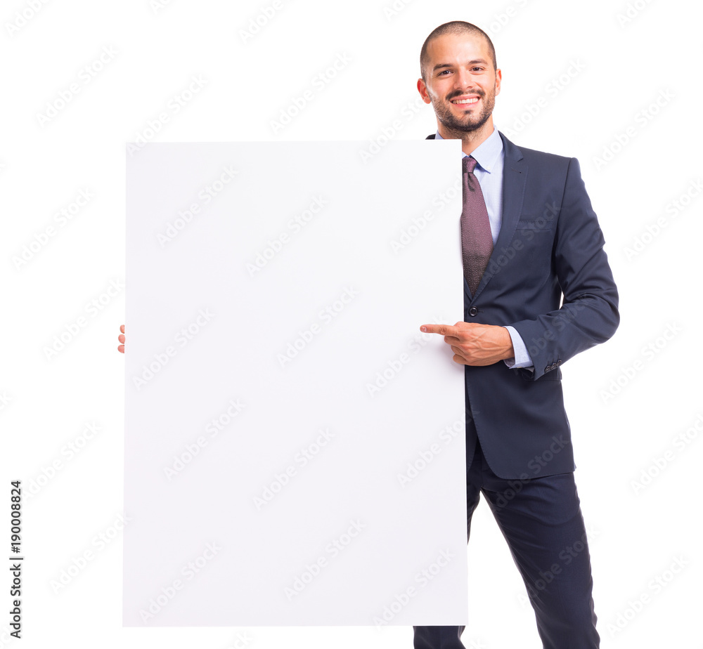 Portrait of happy smiling young businessman pointing to blank board Portrait of happy smiling young businessman pointing to blank board