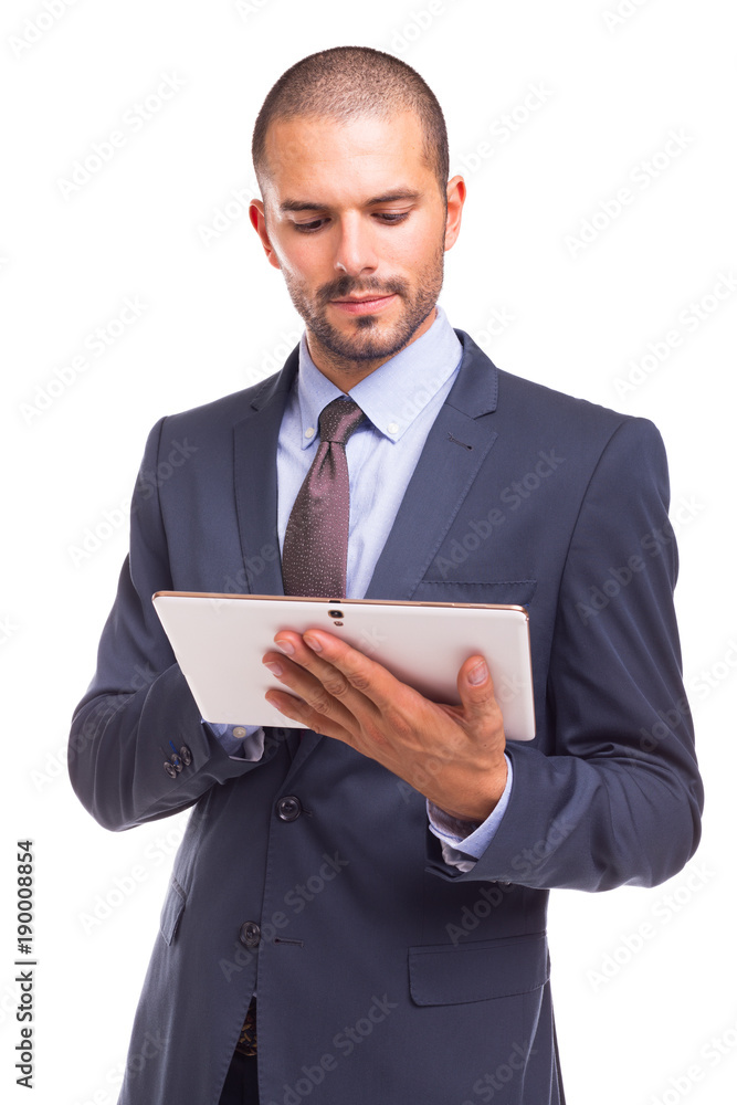 Handsome businessman standing looking to his digital tablet, isolated on a white background Handsome businessman standing looking to his digital tablet, isolated on a white background