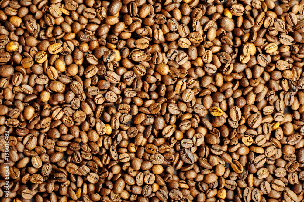Coffee beans on a black textured background. Coffee beans on a black textured background.